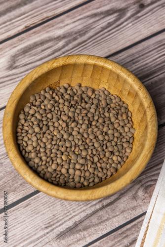 A bamboo bowl filled with dried lentils