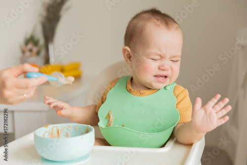 a child of 1 year is naughty at the table, does not want to eat. The concept of feeding a child, the first
