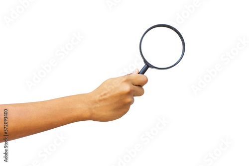 A man's hand holds a magnifying glass
