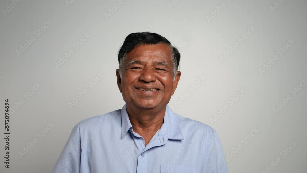 Smiling senior man looking at camera. Close up video portrait Asian elderly man alone at home. Smiling senior man looking at camera. Close up video portrait Asian elderly man alone at home.
