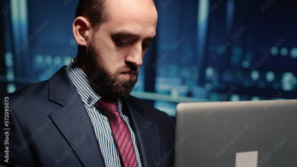 Male professional server IT engineer using laptop in data center, working on computer mainframe processor and running diagnostics on cloud computing connection, artificial intelligence. Handheld shot. Male professional server IT engineer using laptop in data center, working on computer mainframe processor and running diagnostics on cloud computing connection, artificial intelligence. Handheld shot.