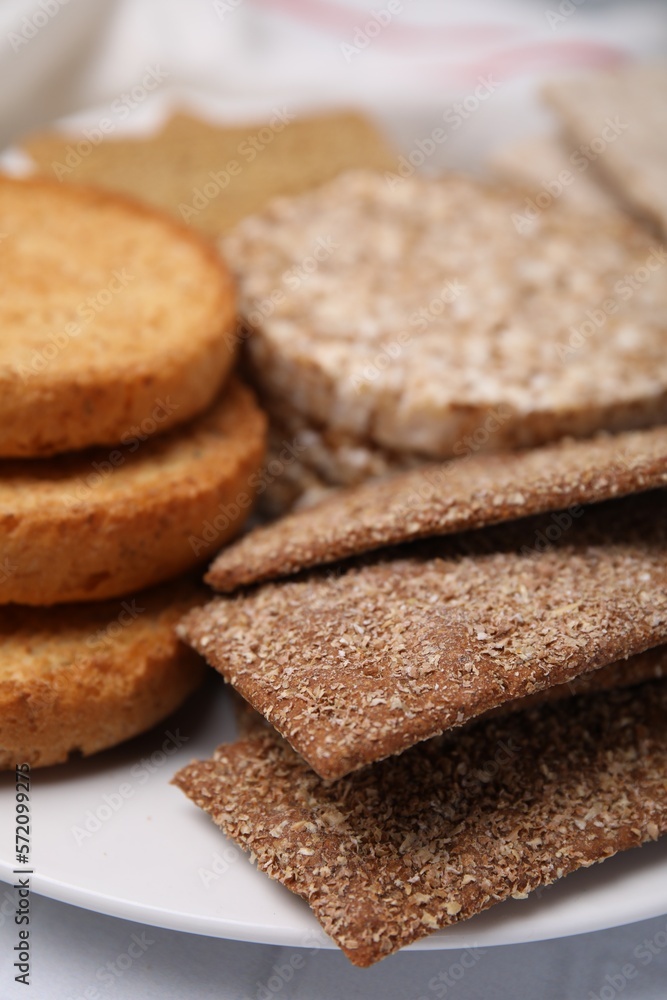 Rye crispbreads, rice cakes and rusks on plate, closeup Rye crispbreads, rice cakes and rusks on plate, closeup