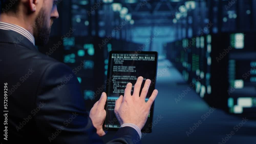 Support specialist checking server computers on tablet, planning mainframe system backup in server room. Information security officer running diagnostics, cloud computing. Handheld shot. Support specialist checking server computers on tablet, planning mainframe system backup in server room. Information security officer running diagnostics, cloud computing. Handheld shot.
