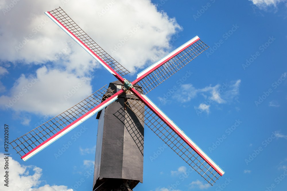 Rustic wooden windmill in idyllic Bruges public park, Belgium