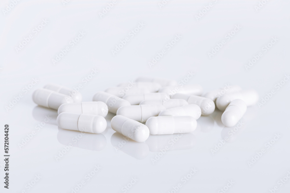 White capsules on white