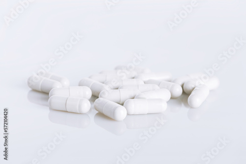 White capsules on white