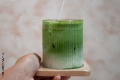 Hand holding iced matcha greentea photo