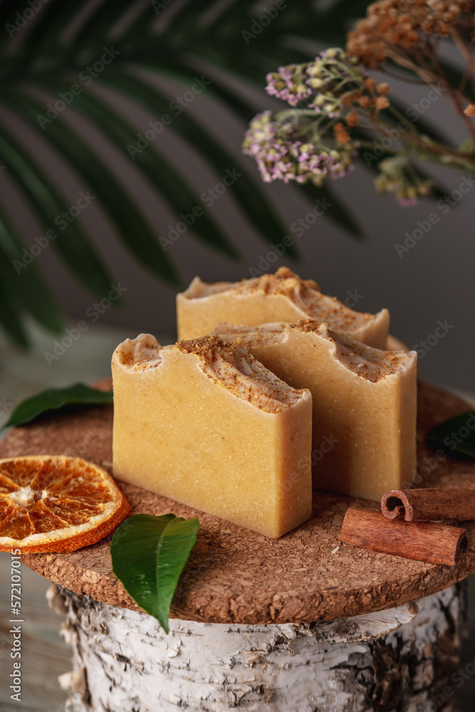 Natural orange soap on the wooden background. Concept of making and using organic eco soap and cosmetics