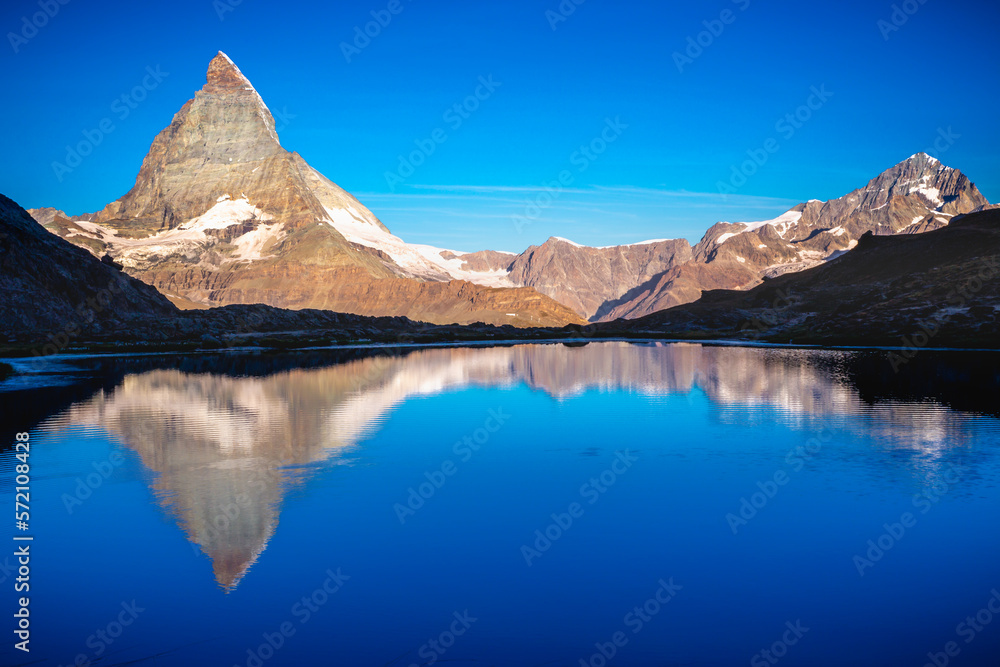 Reflection of the Matterhorn on blue lake at sunrise, Swiss Alps, Zermatt