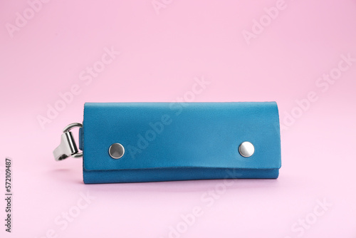 Stylish leather keys holder on pink background