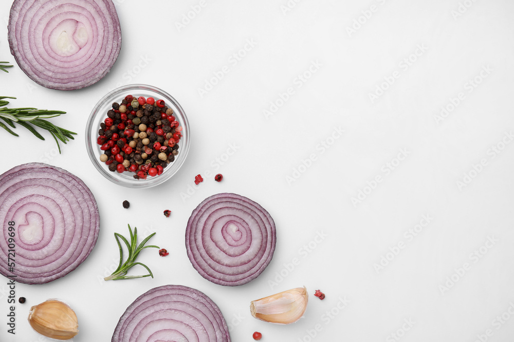 Fresh red onions, garlic, rosemary and spices on white background, flat lay. Space for text Fresh red onions, garlic, rosemary and spices on white background, flat lay. Space for text
