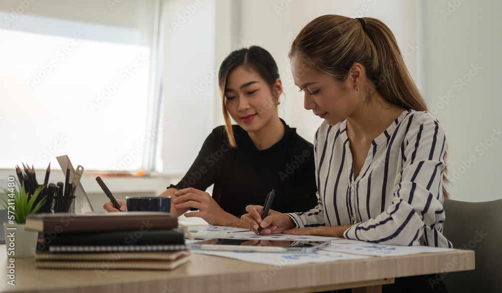 Image of two female managing directors discussing ideas of project and planning work at modern office. Image of two female managing directors discussing ideas of project and planning work at modern office.