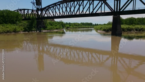 Fairview Lift Bridge, Reflection on Water, Montana, Drone Flying Towards and Low Angle Tilt Up Reveal photo