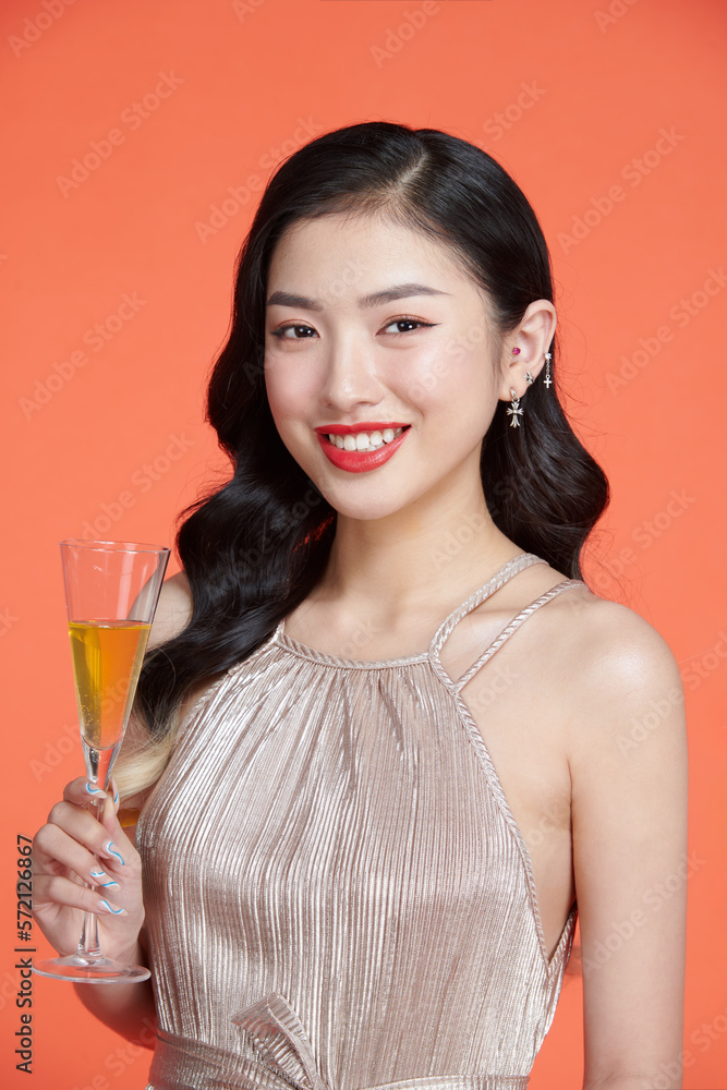 Stylish woman in glamour dress holding glass of champagne, having fun on new year holiday Stylish woman in glamour dress holding glass of champagne, having fun on new year holiday