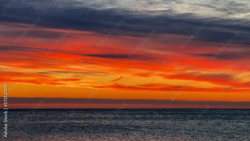 Sea waves are crashing on the Black Sea coast. Waves splash on the beach with pebbles in the rays of the sun. Sunset on the Black Sea. Panoramic view of the Black Sea. Sunset on the beach. Russia