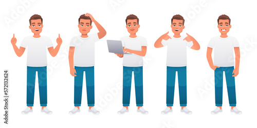 The guy stands radiating confidence, thoughtfully, with a laptop in his hands, points to something. A young caucasian male in a white t-shirt and blue jeans stands in various poses. 