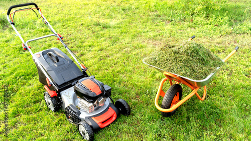 Lawn mover on green grass in modern garden. Machine for cutting lawns.