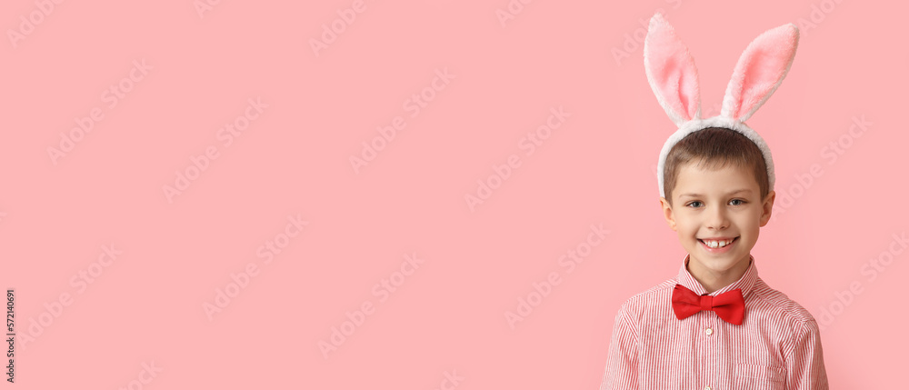 Funny little boy with bunny ears on pink background with space for text