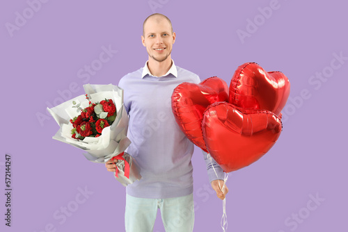 Young man with bouquet of f...
