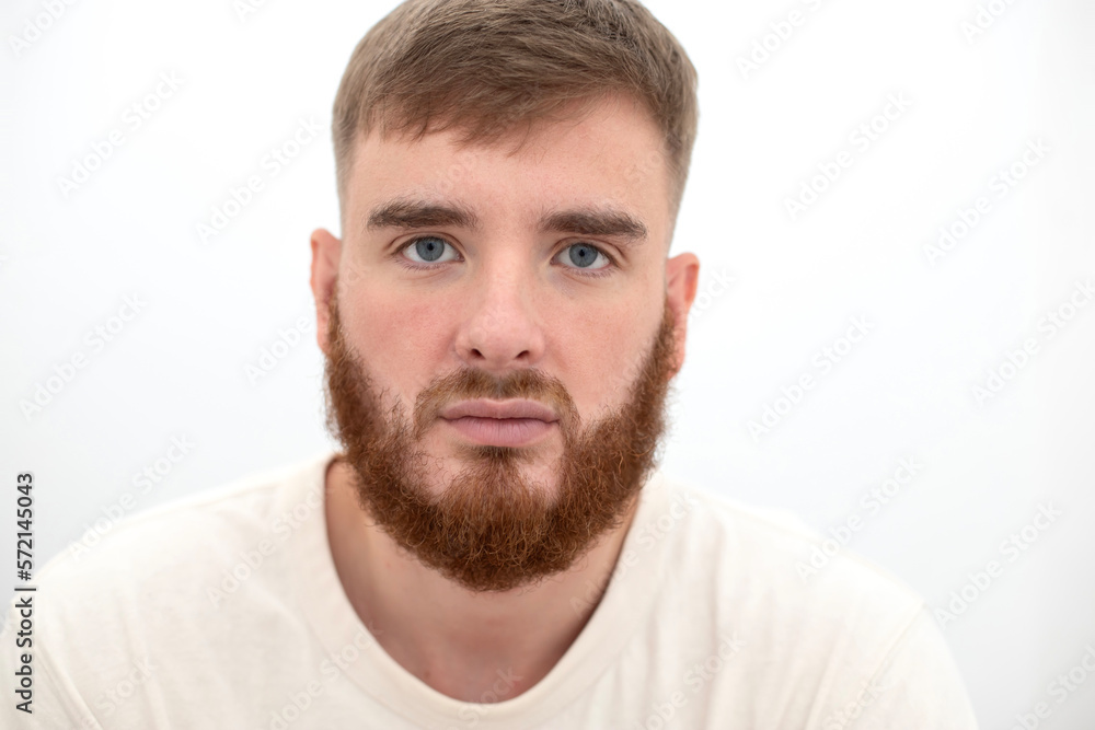 Portrait of bearded happy young handsome man with beard is smiling on white background and looking at camera Portrait of bearded happy young handsome man with beard is smiling on white background and looking at camera