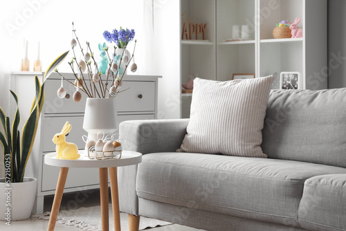 Sticker Vase with tree branches, Easter eggs and rabbit on table in interior of living r