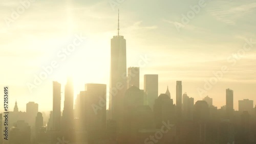 Tight aerial slider shot of New York city financial district skyscrapers at sunrise