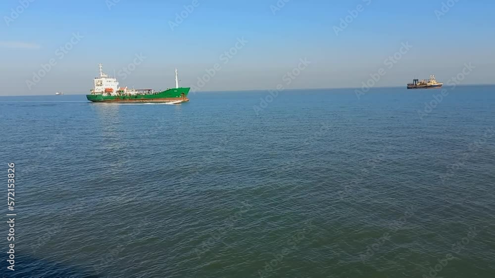 Fishing boats along the coast of Guinea Bissau in the Atlantic ocean. A small boat passes at great speed Fishing boats along the coast of Guinea Bissau in the Atlantic ocean. A small boat passes at great speed
