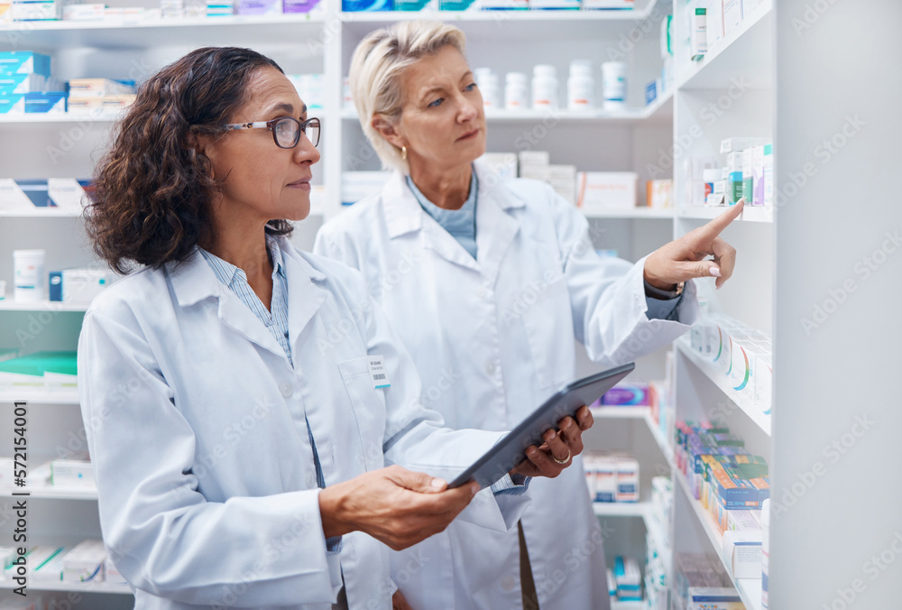 Tablet, teamwork and pharmacists check stock in pharmacy, drugstore or shop for medication. Medicine, technology and medical doctors or senior women with touchscreen for checking product inventory.