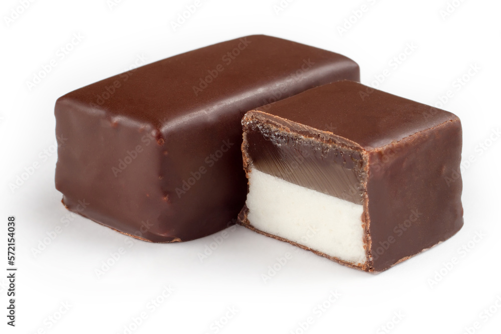 Chocolate candies stuffed on a white background. Whole and half candy. Chocolate candies stuffed on a white background. Whole and half candy.