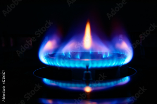 Blue flame of a portable gas stove used for cooking. Gas provides a convenient source of instant heat and is an alternative to electricity.