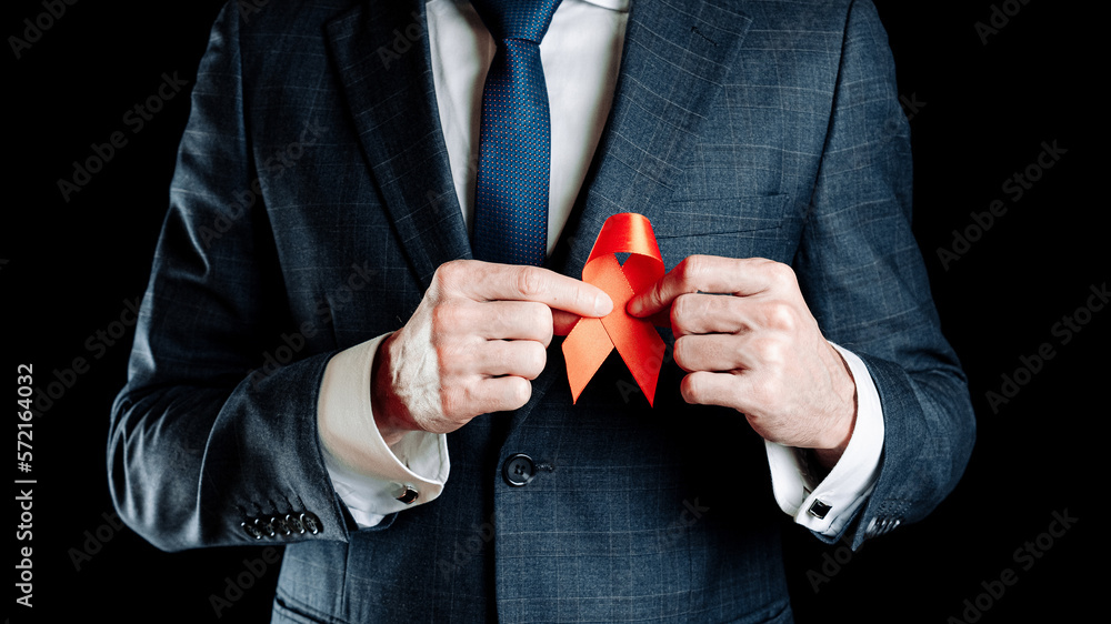 Hiv ribbon. Red ribbon in hiv world day in man hand. Awareness aids and ...