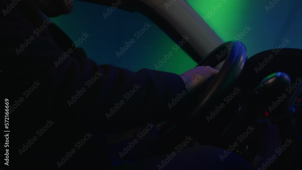 Close-up of a Confident Male Driver Steering a Car with Precision and Control on a Tunnel Road Close-up of a Confident Male Driver Steering a Car with Precision and Control on a Tunnel Road