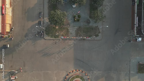 Drone footage above Stung Treng city center a quiet border town of Cambodia with Laos. Camera is moving foward camera is looking the ground 1-2 photo