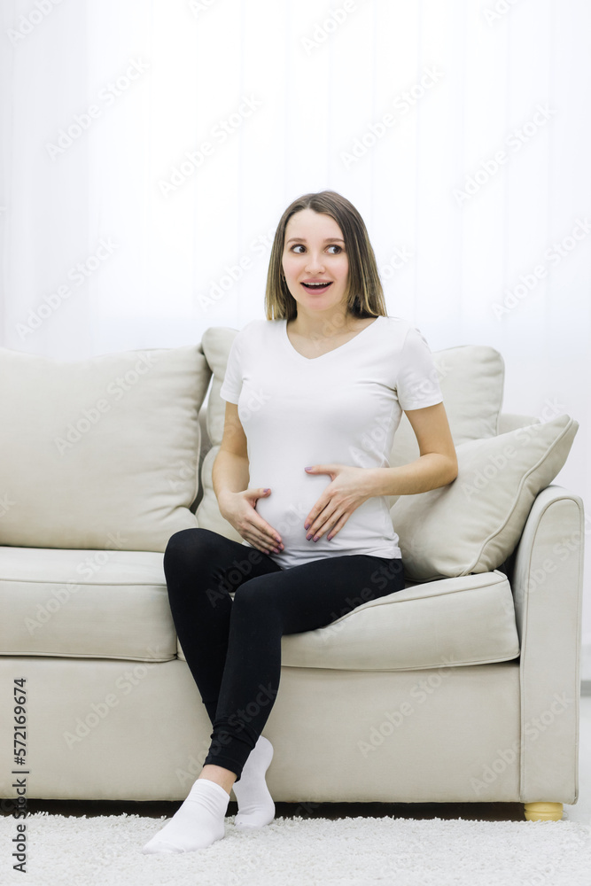 Cute woman looking on the right in the living room.