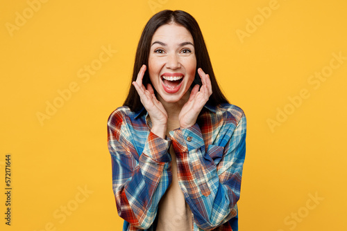 Young promoter fun woman wear blue shirt beige t-shirt scream sharing hot news about sales discount with hands near mouth isolated on plain yellow background studio portrait. People lifestyle concept. © ViDi Studio