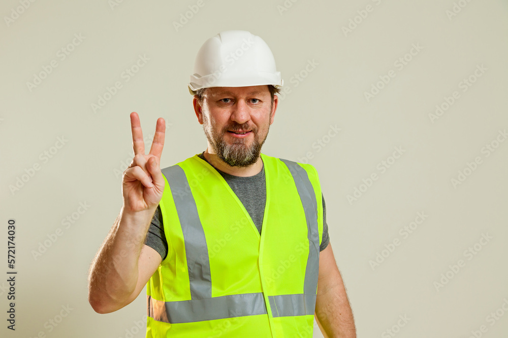 worker in a vest and white helmet