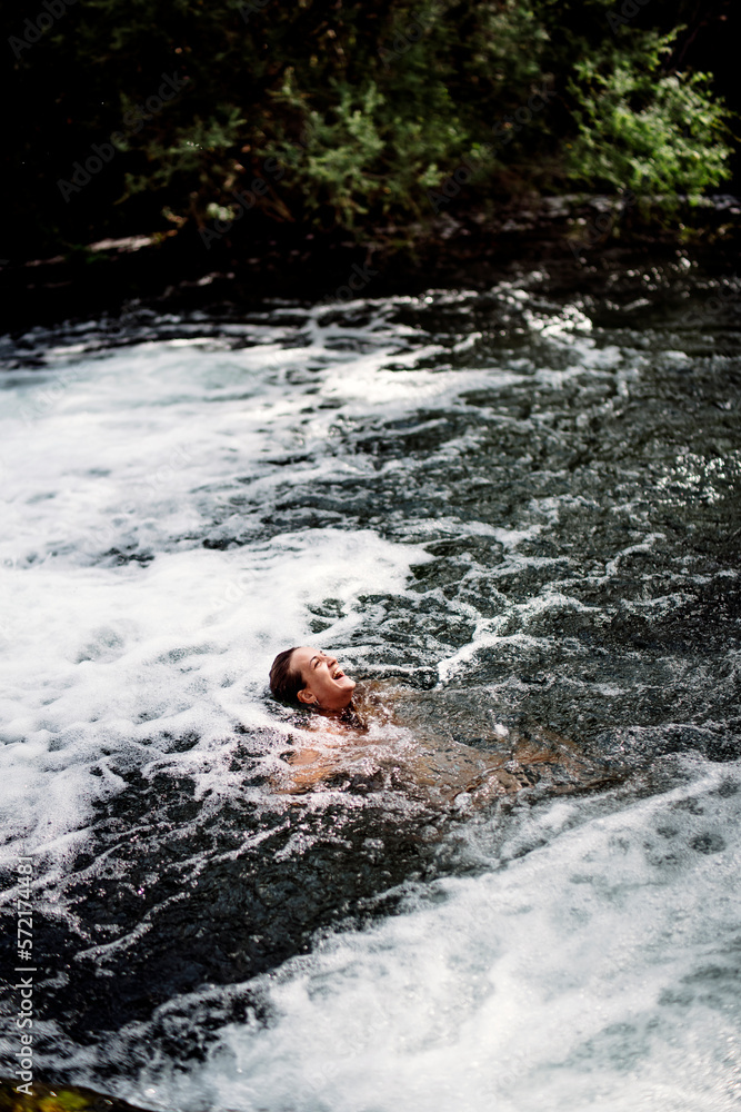 Blond woman bathing in beautiful river waterfall. Blond woman bathing in beautiful river waterfall.