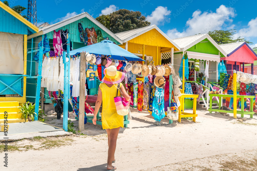 Woman looking at souvenirs at beach market, Long Bay Beach, Antigua Woman looking at souvenirs at beach market, Long Bay Beach, Antigua