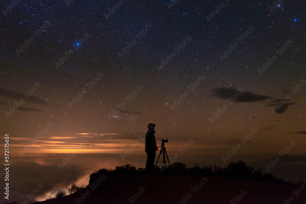 Man photographing the starry sky after sunset Man photographing the starry sky after sunset