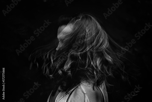 Black and white portrait of a female swishing hair