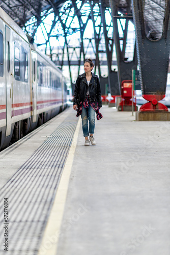 Wallpaper Mural Walking woman in a leather jacket on the railway departure platform Torontodigital.ca