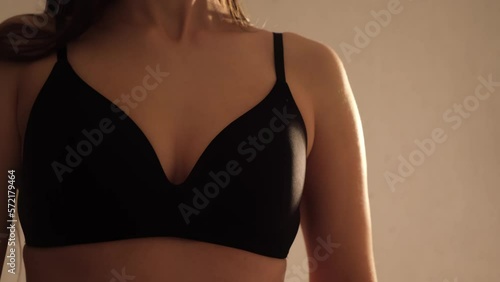 Hot girl. Sexy female boob in black bra close-up. Natural woman breast. Copy space. Erotically in bed. Line silhouette of naked body. Sensual erotica. Tanned ladies skin. Lingerie dance. Slim model.