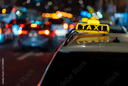 Berlin Germany Illuminated Taxi sign on a car in a busy street at night