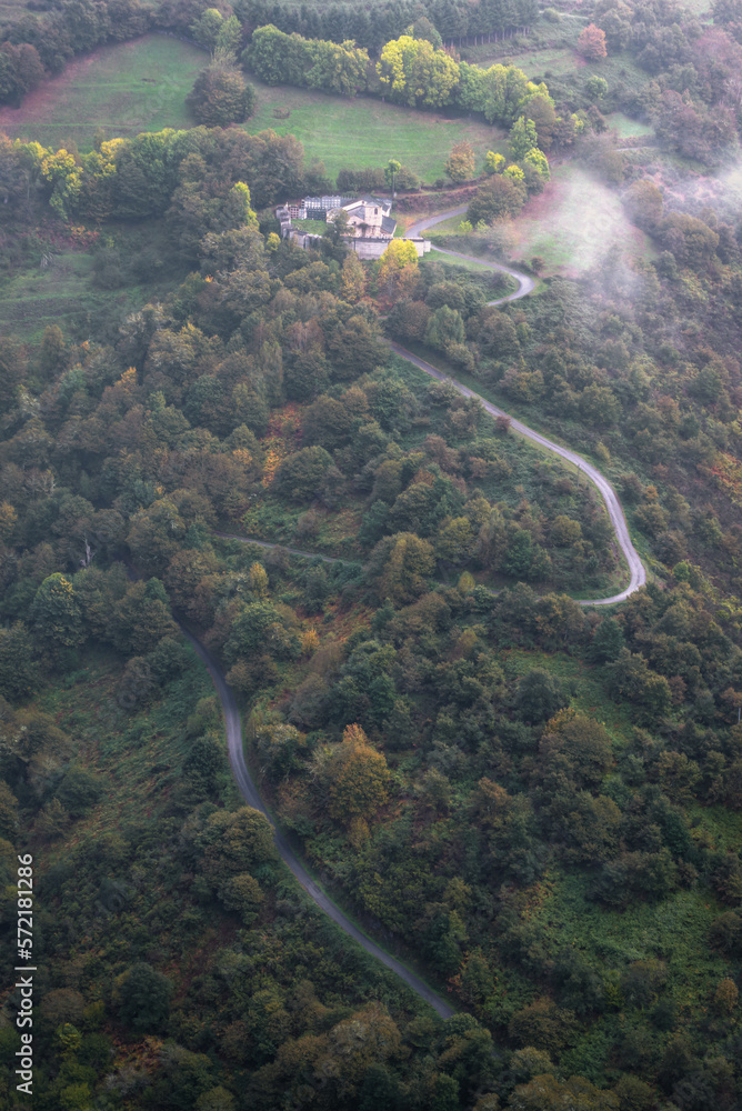 A winding narrow road leads to a small chapel with cemetery in the Ancares Mountain Range Cervantes Lugo Galicia