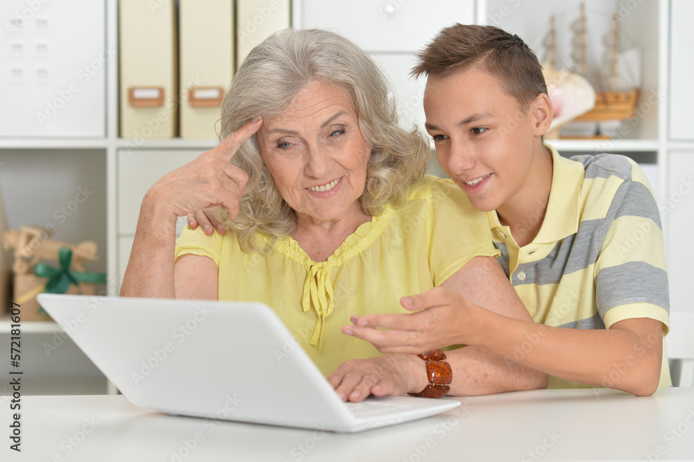 Grandmother with grandson using laptop at home Grandmother with grandson using laptop at home