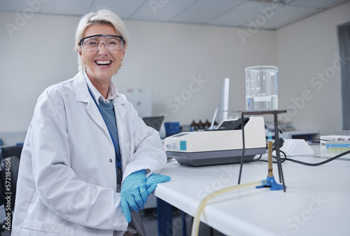 Mature woman, portrait or laboratory glass in science research, future dna engineering or bacteria analytics on fire. Happy, smile or scientist equipment in healthcare pharmacy test or medical study