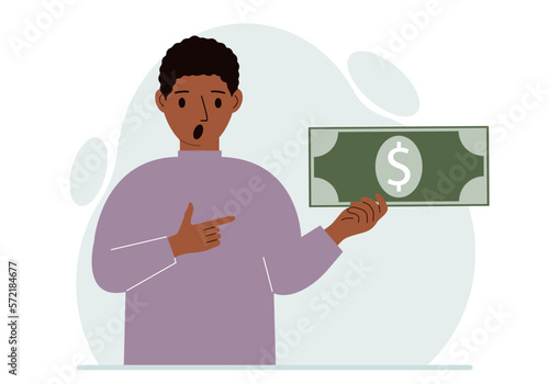 A man holds a large paper bill in his hand. The concept of income, expense, earning or spending money.