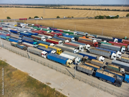 A long line of trucks in the port terminal. Trucks are waiting to unload grain.