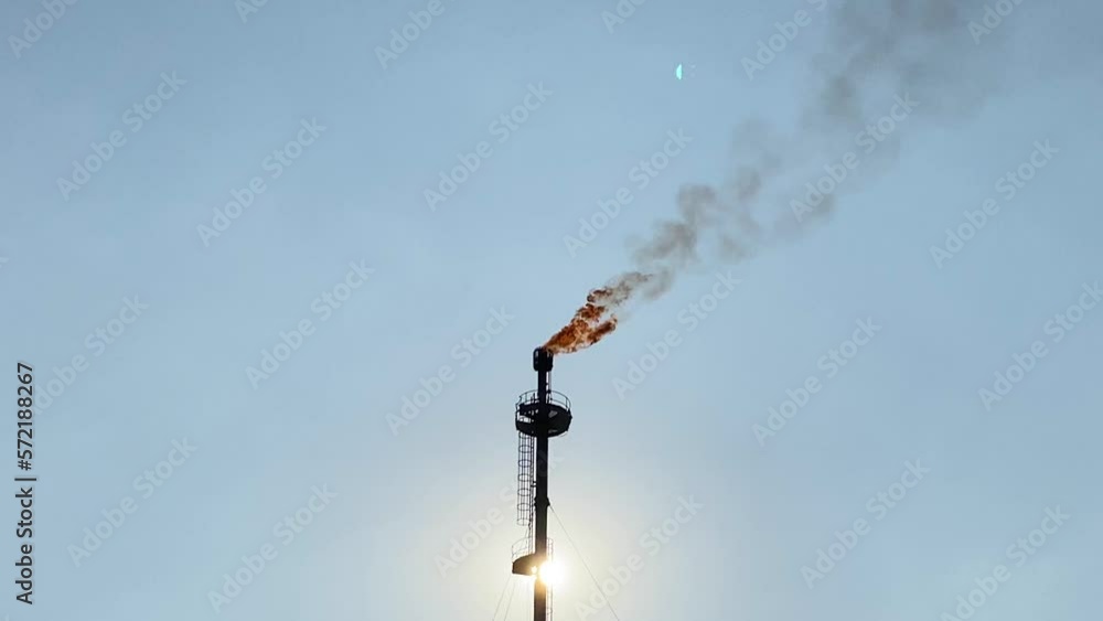 Hand-held shot of an oil refinery burning gas Hand-held shot of an oil refinery burning gas