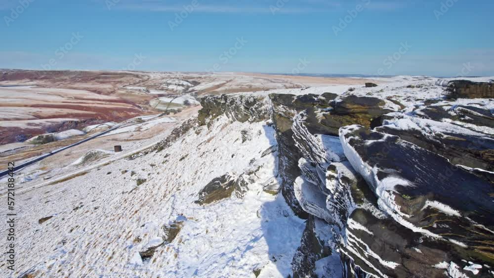 Cinematic cold winter aerial view, Aerial Winter snow scene. Yorkshire winter scene. Rocky outcrop. Gritstone cliff edge. Stanage Edge. Cinematic cold winter aerial view, Aerial Winter snow scene. Yorkshire winter scene. Rocky outcrop. Gritstone cliff edge. Stanage Edge.